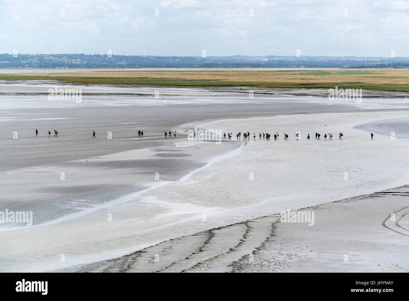 La gente caminando en la arena durante la marea baja, el Mont-Saint-Michel, en Normandía, Francia, Europa Foto de stock