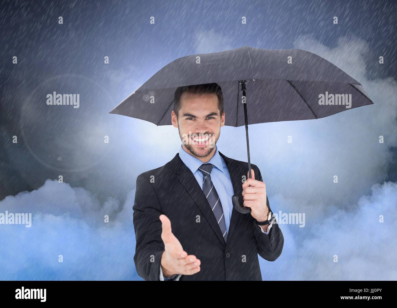 Hombre sosteniendo el paraguas bajo la Foto de stock 2281857573