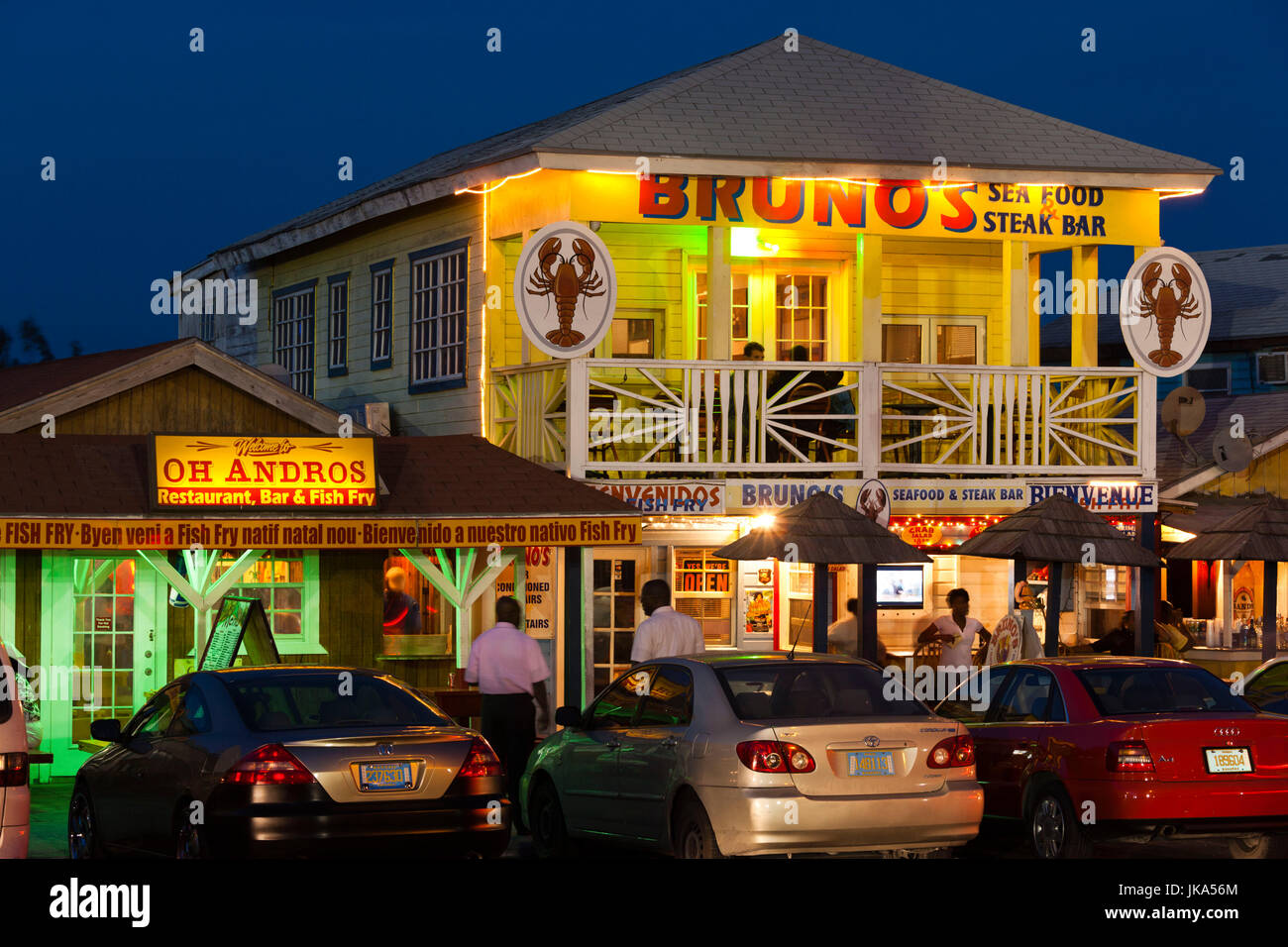 En la isla de Nueva Providencia, Bahamas, Nassau, Arawak Cay, restaurantes de pescado frito, signos, el anochecer Foto de stock