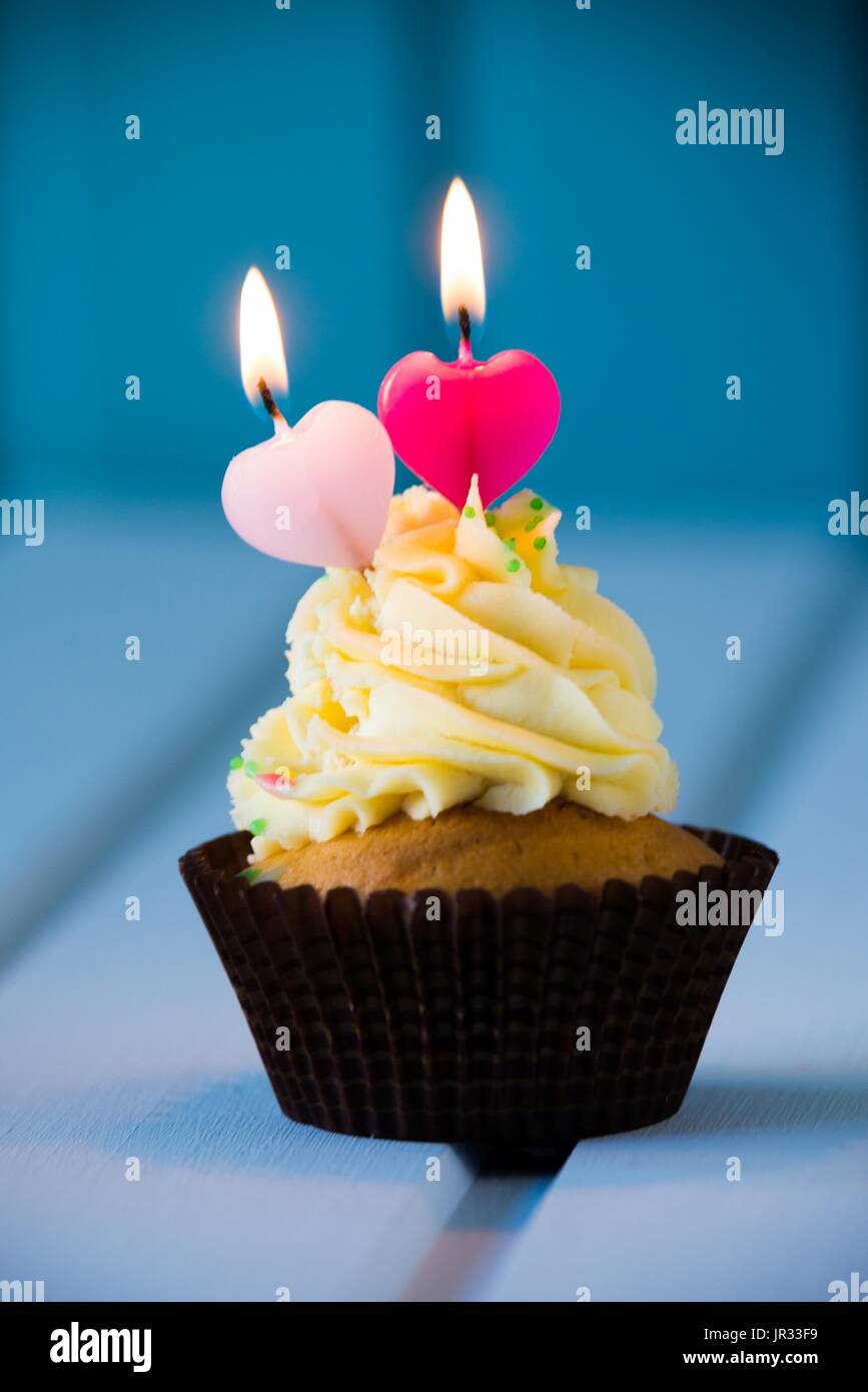 La torta de cumpleaños - cupcake con velas en forma de corazón para 2 -  segundo cumpleaños o el día de San Valentín Fotografía de stock - Alamy