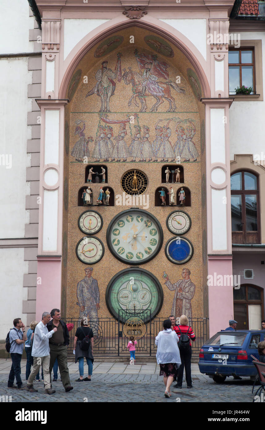 La gente en frente del reloj astronómico en Olomouc, República Checa. El reloj histórico, una vez colocados fuera del Ayuntamiento de Olomouc fue gravemente dañada durante la Segunda Guerra Mundial y reconstruido en el estilo del realismo socialista del artista checo Karel Svolinský en la década de 1950. Foto de stock