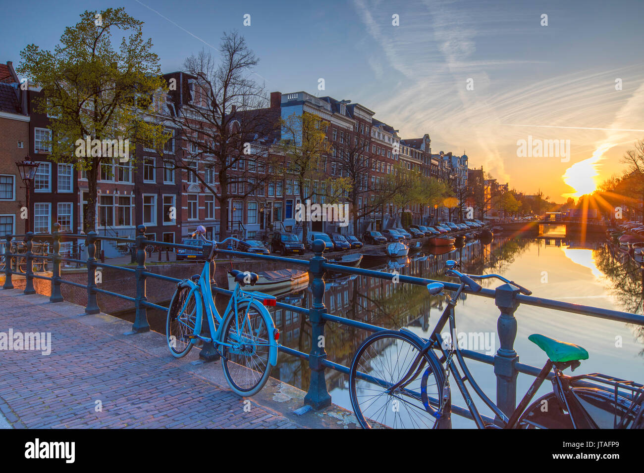 Bicicletas en el canal Keizersgracht al amanecer, Amsterdam, Países Bajos, Europa Foto de stock