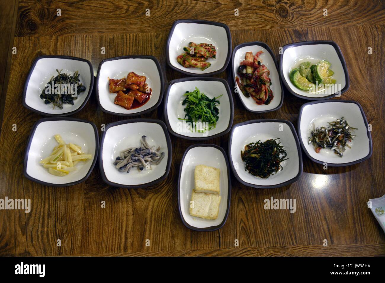 Una variedad de Corea del Sur los famosos platos de verduras fermentadas, incluyendo el kimchi en un restaurante en Danyang, Corea del Sur, 21 de marzo de 2013. Los coreanos desarrollaron el Kimchi hace siglos como una forma de garantizar una vitamina rica comida a través de los largos inviernos. Ahora se come con casi cada comida como un plato, y contiene generalmente encurtido sazonado y col y rábano. Uso | en todo el mundo Foto de stock