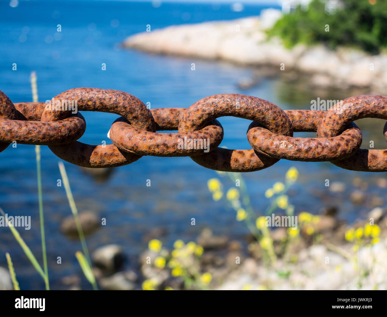 Una cadena oxidada barrera por el océano Fotografía de stock - Alamy