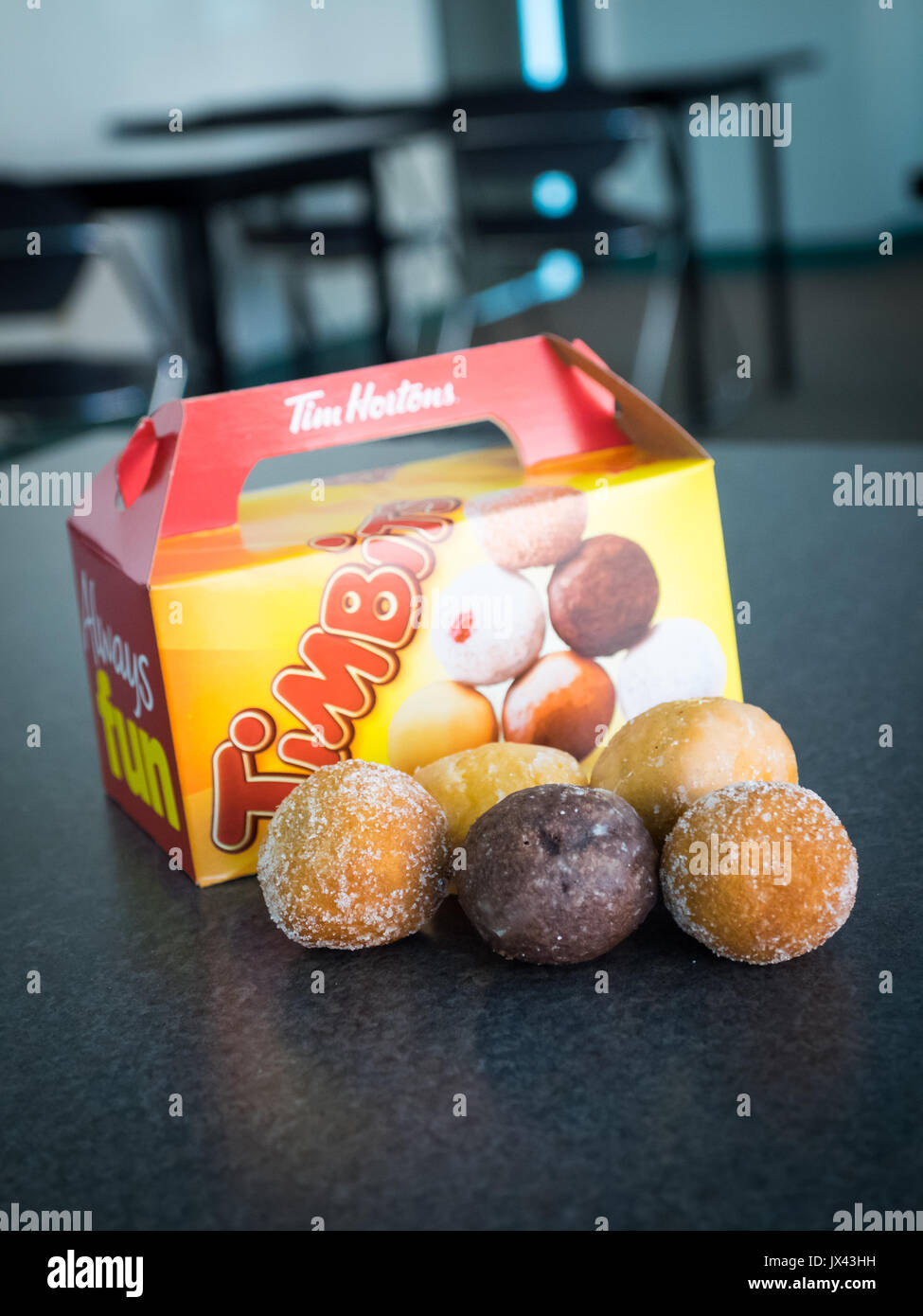 Timbits (agujeros de donut, donut agujeros) de Tim Hortons, una conocida cadena de restaurantes de comida rápida de Canadá. Foto de stock