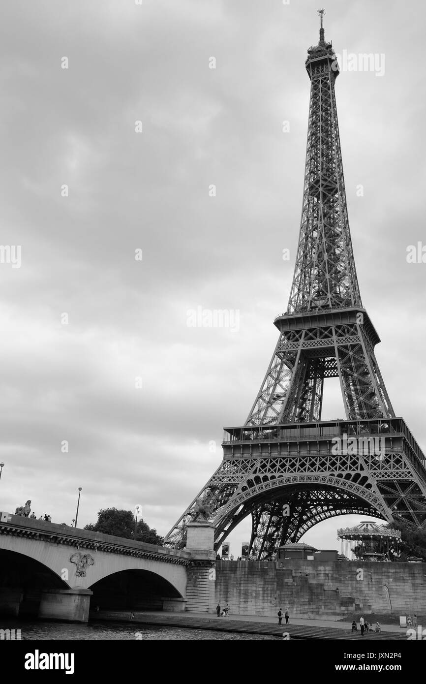 La Torre Eiffel de París, como se ve desde el río Sena en un viaje en barco fotografiado en blanco y negro Foto de stock