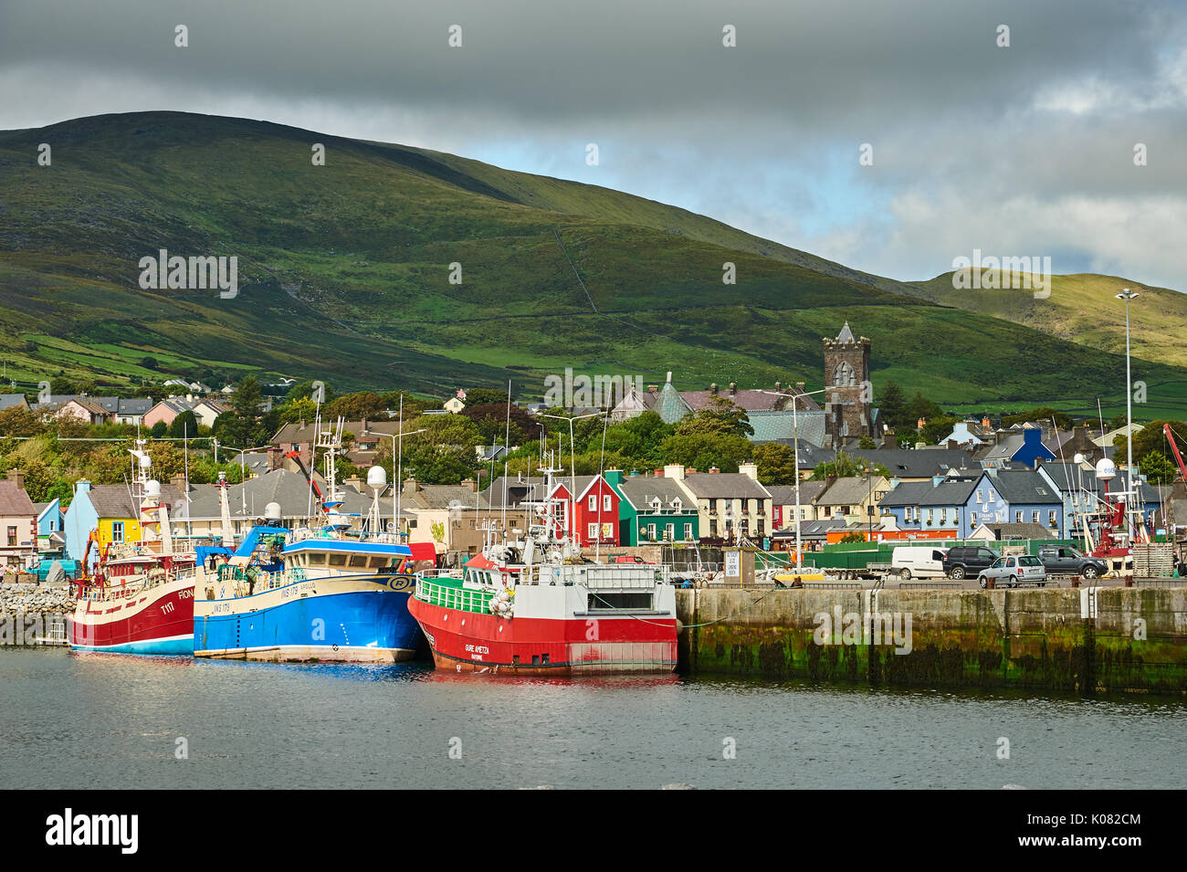 Dingle, Condado de Kerry en la República de Irlanda y una colección de barcos de pesca están amarrados en el pequeño puerto de pescadores. Foto de stock