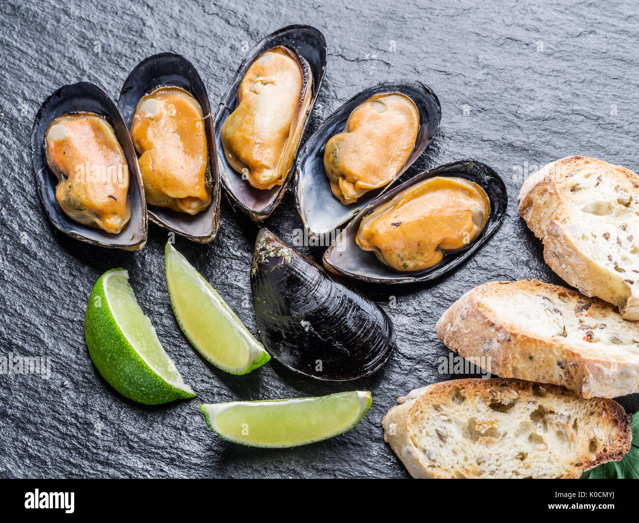 Mejillones hervidos en el fondo de grafito. Foto de stock