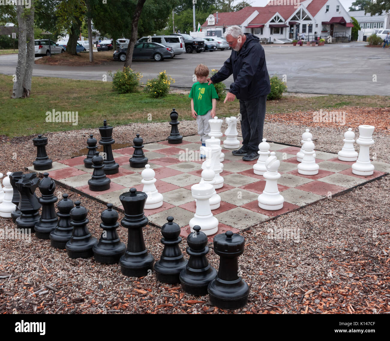 Abuelo nieto enseñanza cómo jugar al ajedrez. Foto de stock