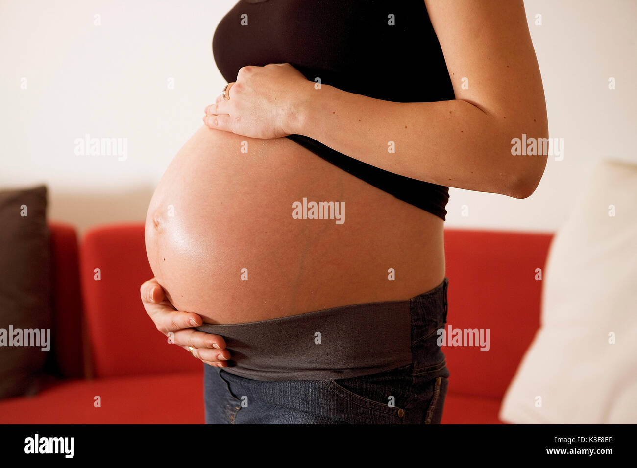 Joven Embarazada mantiene el abdomen Foto de stock