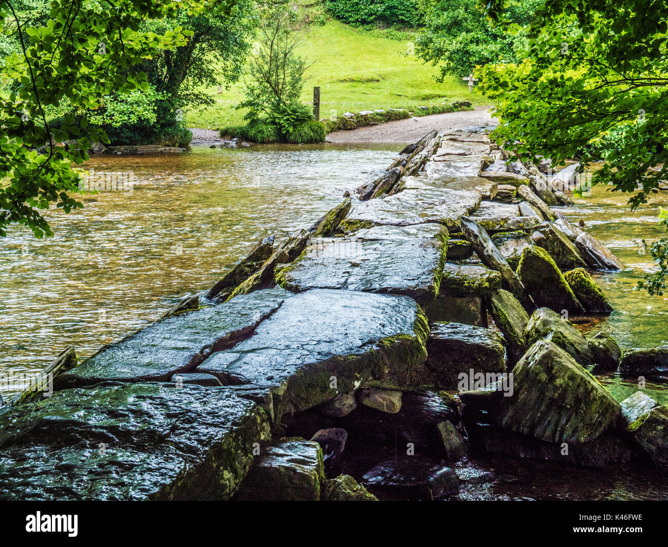 Un día lluvioso en Tarr Steps, el famoso 17-span medival badajo puente que cruza el río Barle en Exmoor, Somerset. Foto de stock