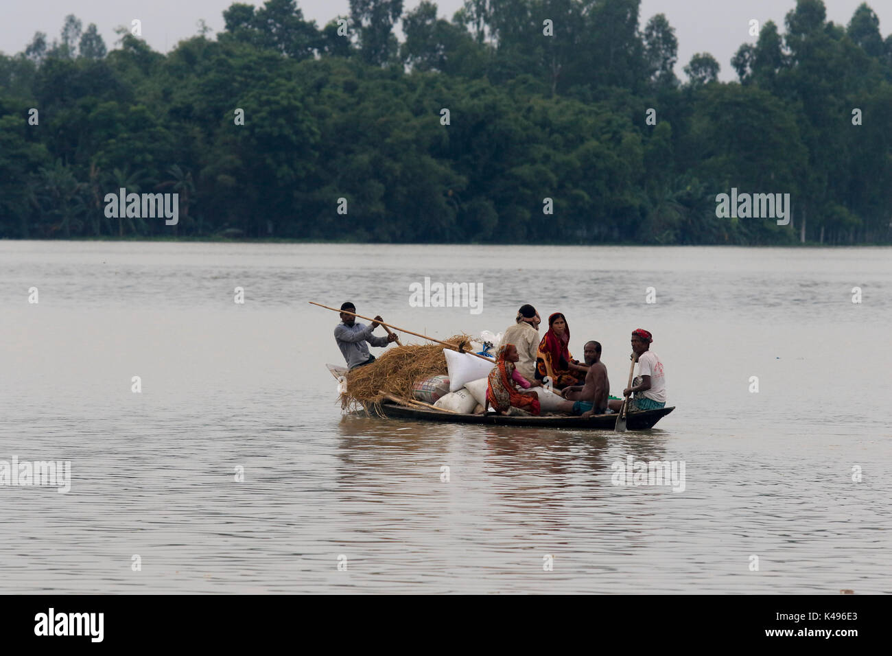 Una familia se escapa de las inundaciones en sarkarpara ulipur upazila de kurigram en Bangladesh. Foto de stock