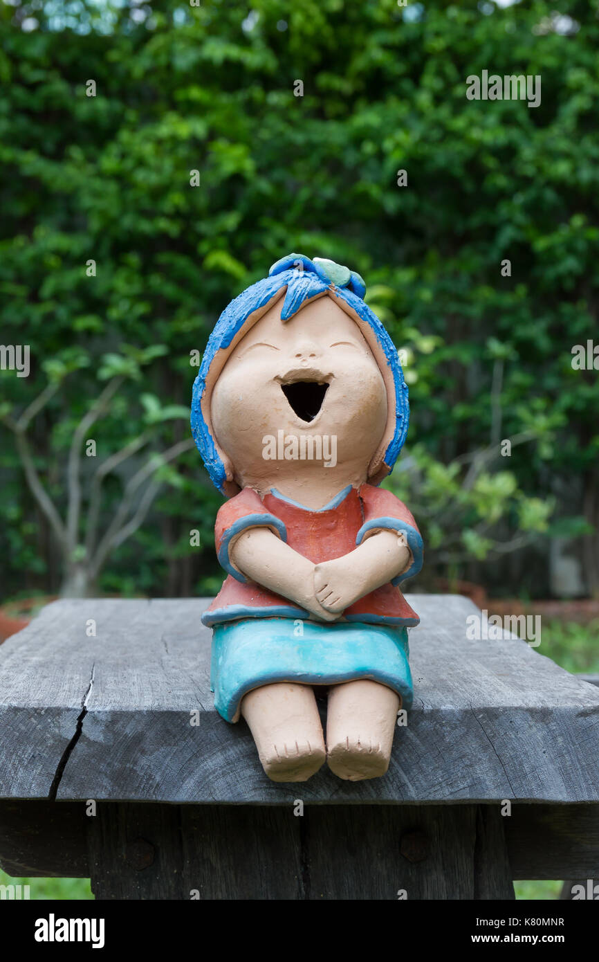 Riendo muñeco de arcilla sentarse en la silla de madera Fotografía de stock  - Alamy