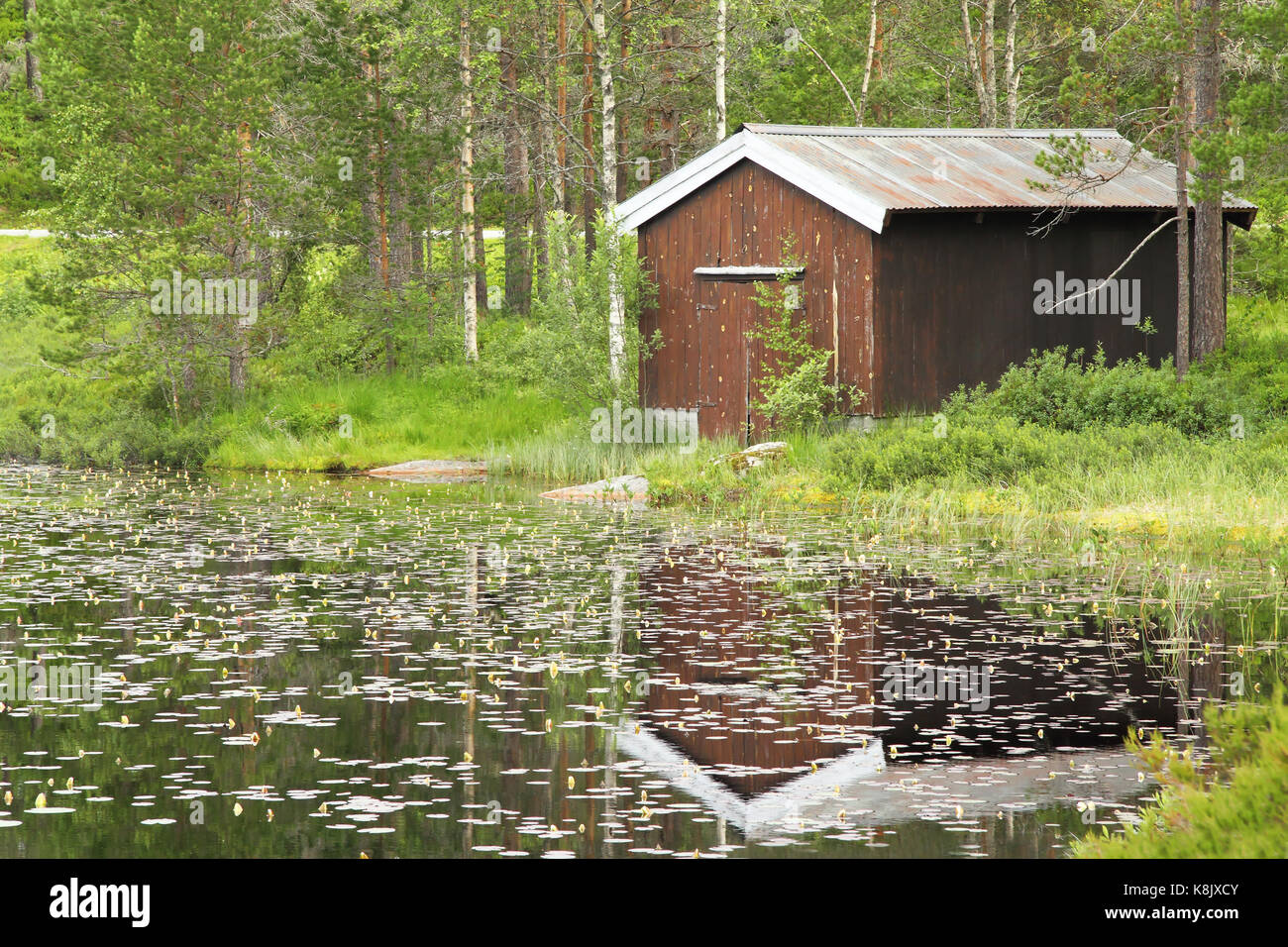 Casa reflejo en un lago en Noruega Foto de stock