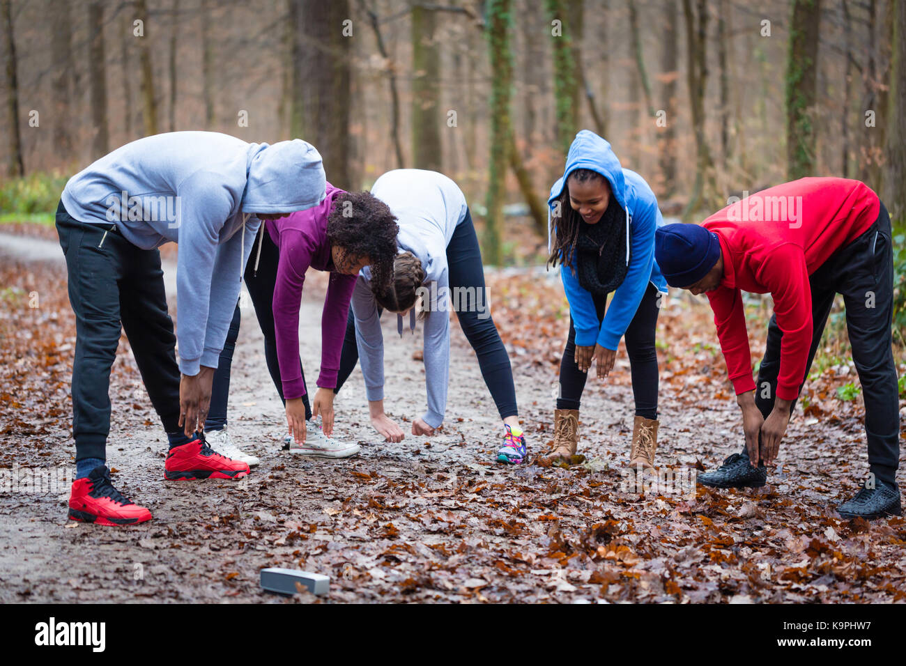 Grupo de gente joven calentando el cuerpo superior al aire libre Fotografía  de stock - Alamy