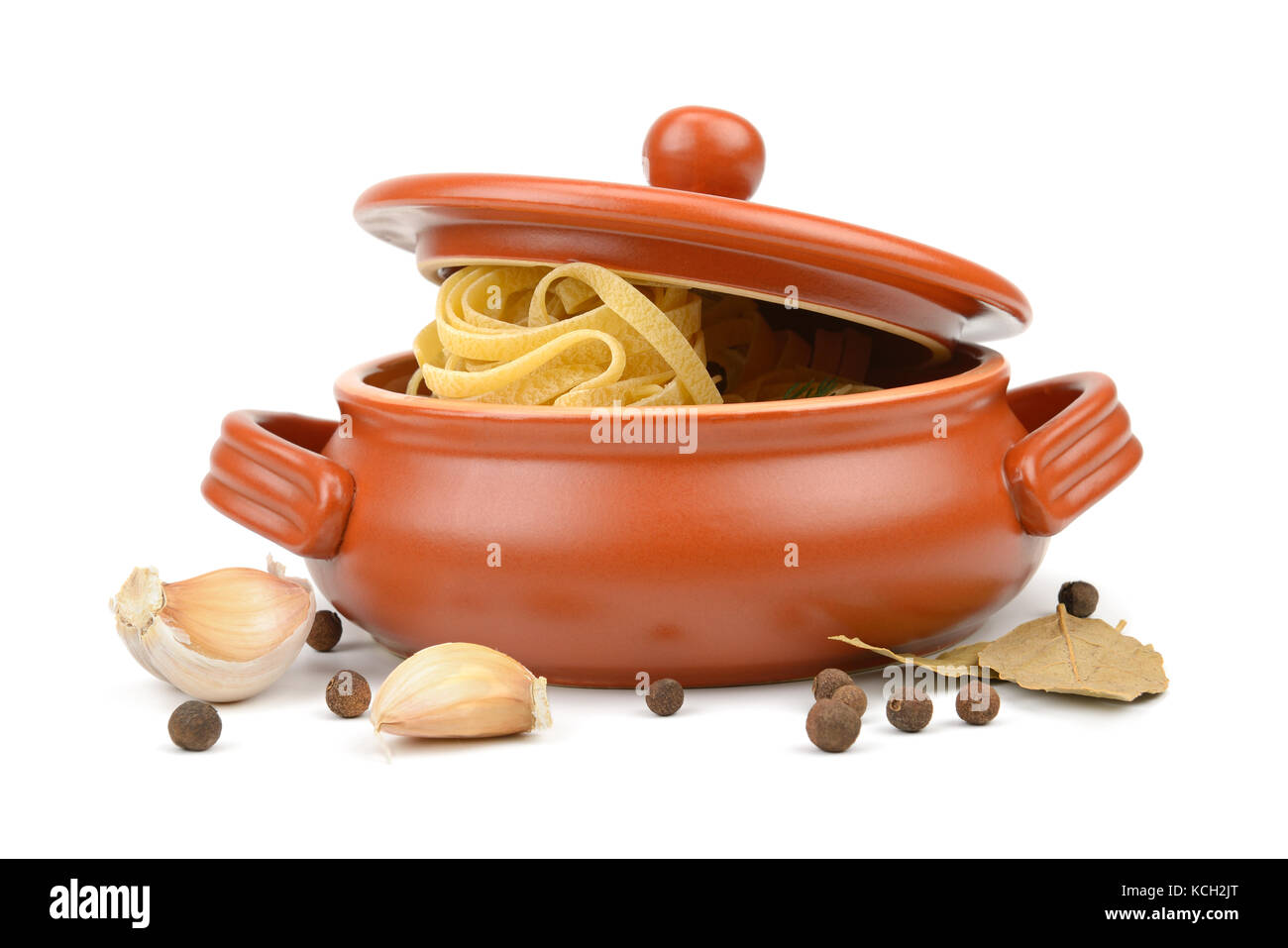 Los espaguetis en una olla de barro aislado en blanco Foto de stock