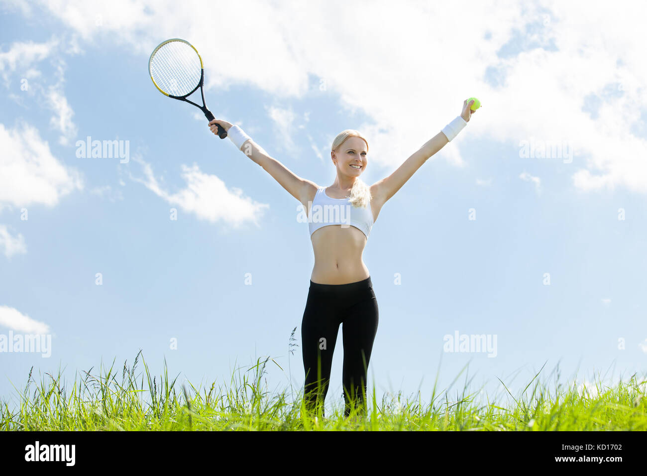Jugador de tenis femenino en el campo de pie sujetando la raqueta y la bola Foto de stock