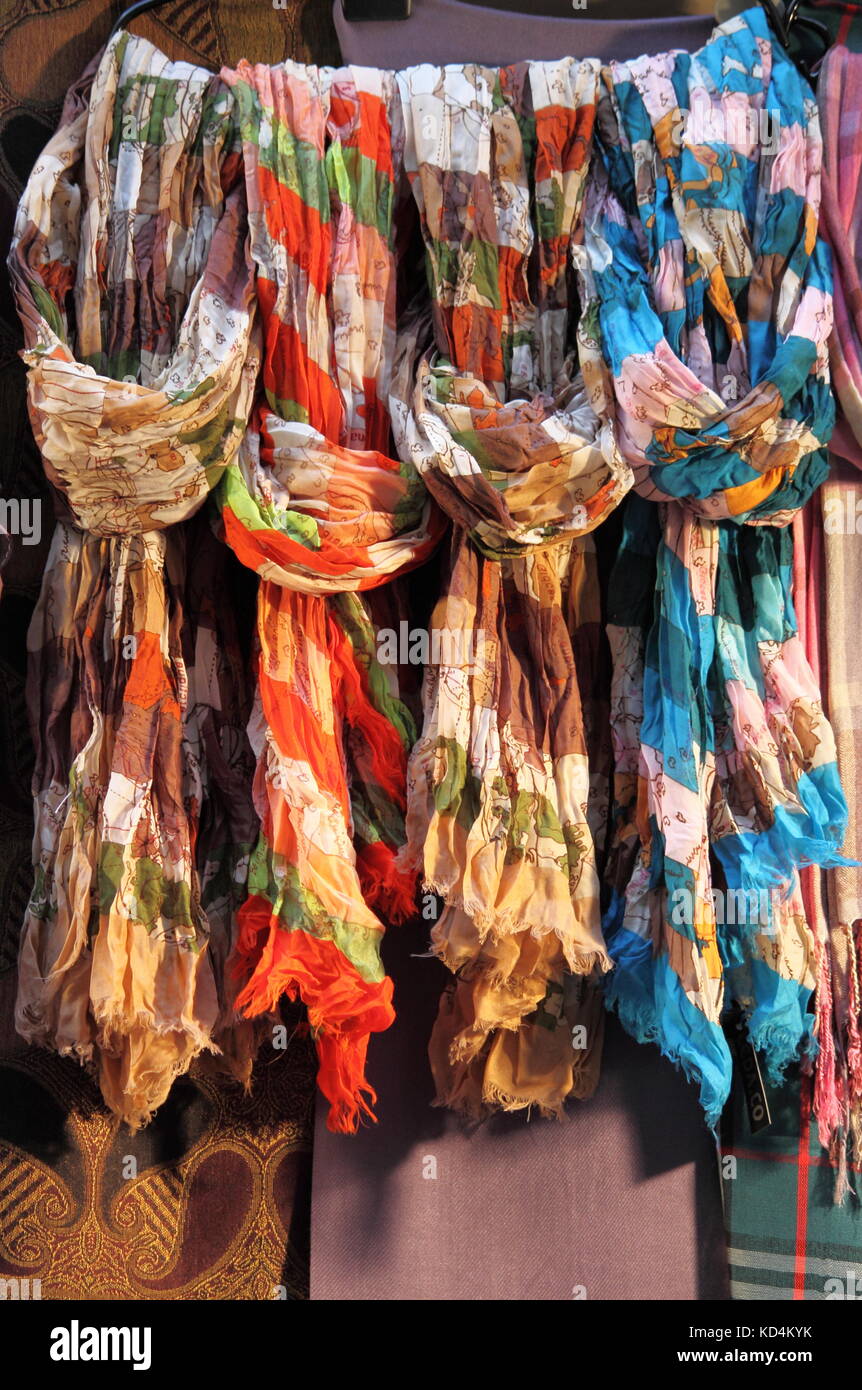 Coloridas bufandas colgadas en una estantería de una tienda de moda  Fotografía de stock - Alamy