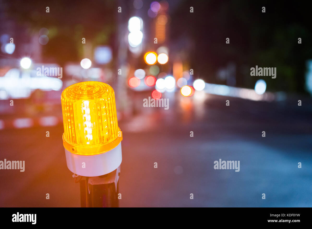 Luz indicadora de zona de construcción en la carretera de la ciudad de noche. Foto de stock