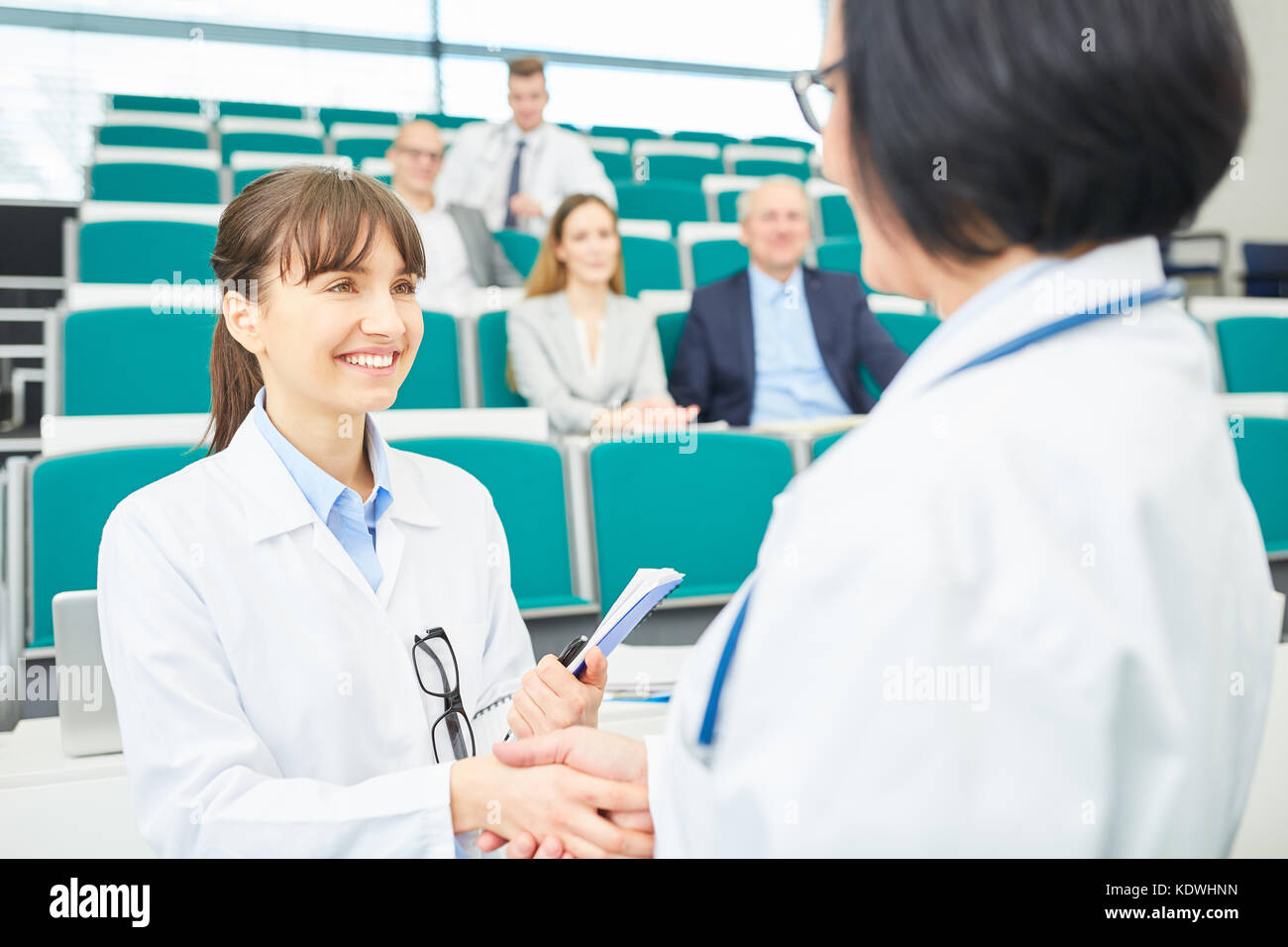 Estudiante de medicina y doctor agitar las manos después de aprobado el examen Foto de stock