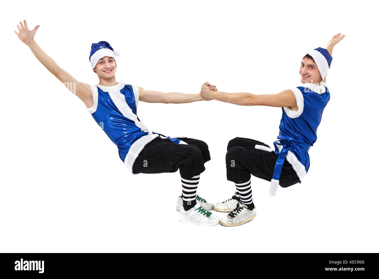 Dos hombres de navidad en azul ropa de santa bailando contra blancos aislados en toda su longitud. Foto de stock