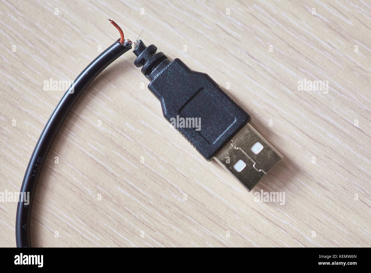 Cable USB roto en una mesa de madera Fotografía de stock - Alamy