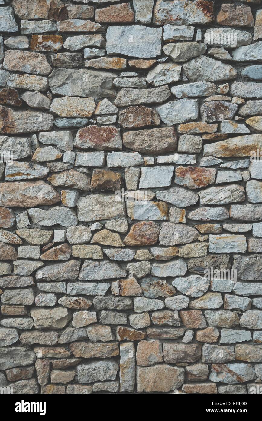 Muro de piedra de las piedras de colores de fondo con película mate