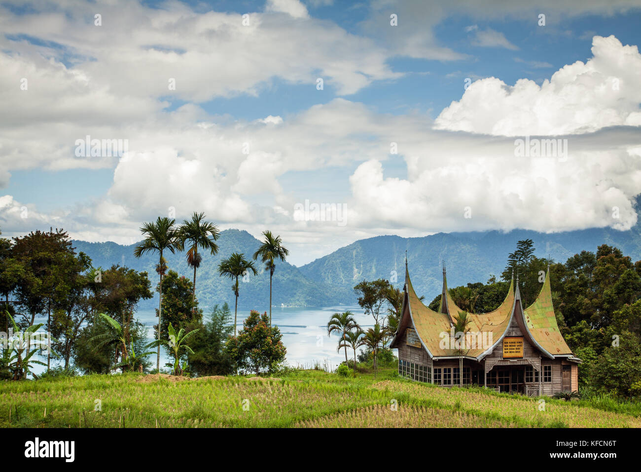 Lago maninjau en Sumatra, Indonesia. hermosa y espectacular paisaje de la antigua caldera volcánica. Montañas, cielo nuboso, minangkabau edificio Foto de stock