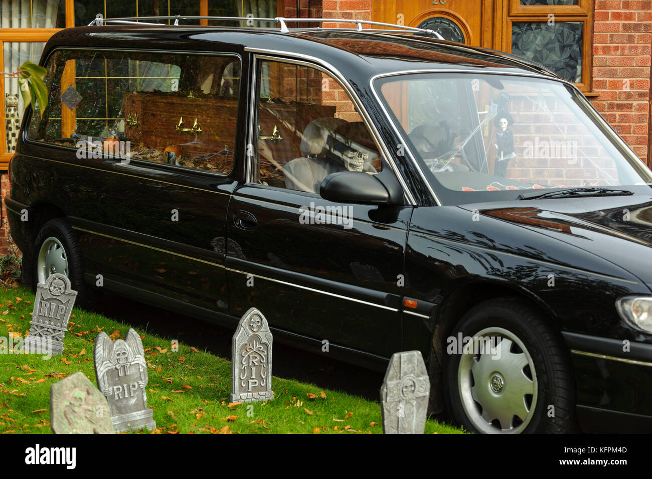 Wirral, Reino Unido. El 31 de octubre de 2017. Pantalla de Halloween fuera de casa ha sido llevado a un nuevo nivel. En la foto aparece una carroza fúnebre, completado con un esqueleto de driver, ataúd, lápidas y diversos adornos espeluznantes. © Paul Warburton Foto de stock