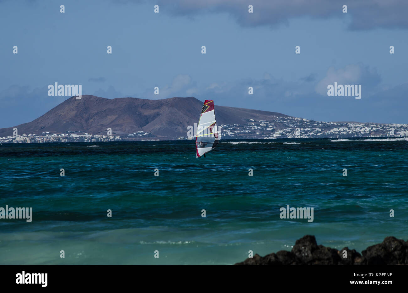 Windsurf impulsada por el viento, corre sobre las olas en Fuerteventura, Islas Canarias Foto de stock