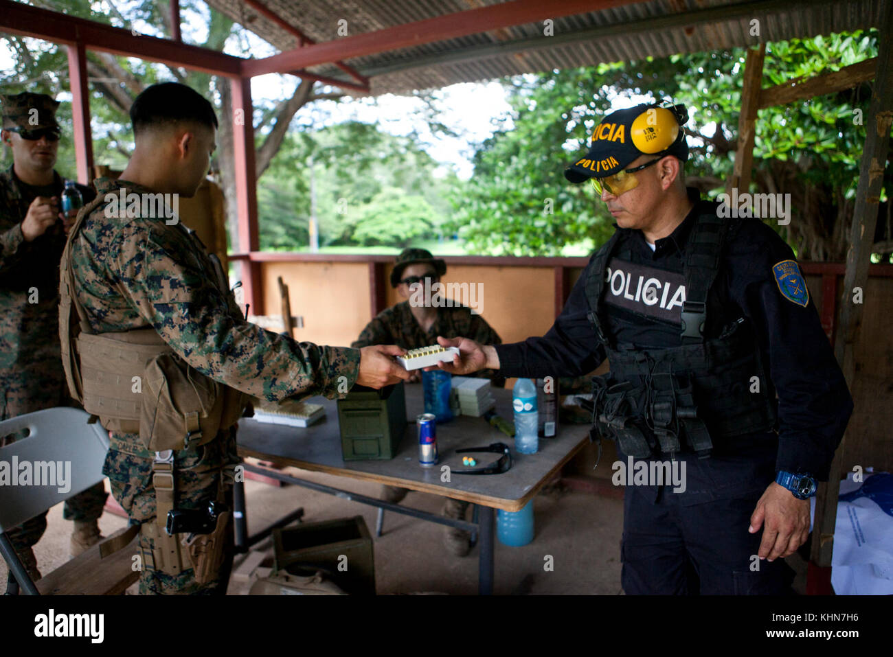 El Sargento de Marina de los EE.UU. Jorge P. Calle, entrenador de infantería con dos equipos móviles de capacitación, elemento de comando, Marina de propósito especial Air-Ground Task Force - Comando Sur, manos municiones a un miembro de la policía costarricense en base policial Murcielago en Cuajiniquil, Costa Rica, 15 de agosto de 2017. El TTM es enseñar habilidades de puntería básica a la fuerza de policía de la nación anfitriona durante su estancia en Costa Rica. Los infantes de Marina y marineros de SPMAGTF-SC se despliegan en América Central para llevar a cabo la cooperación en materia de seguridad de proyectos de ingeniería y capacitación con sus homólogos en varios países centroamericanos y Ca Foto de stock