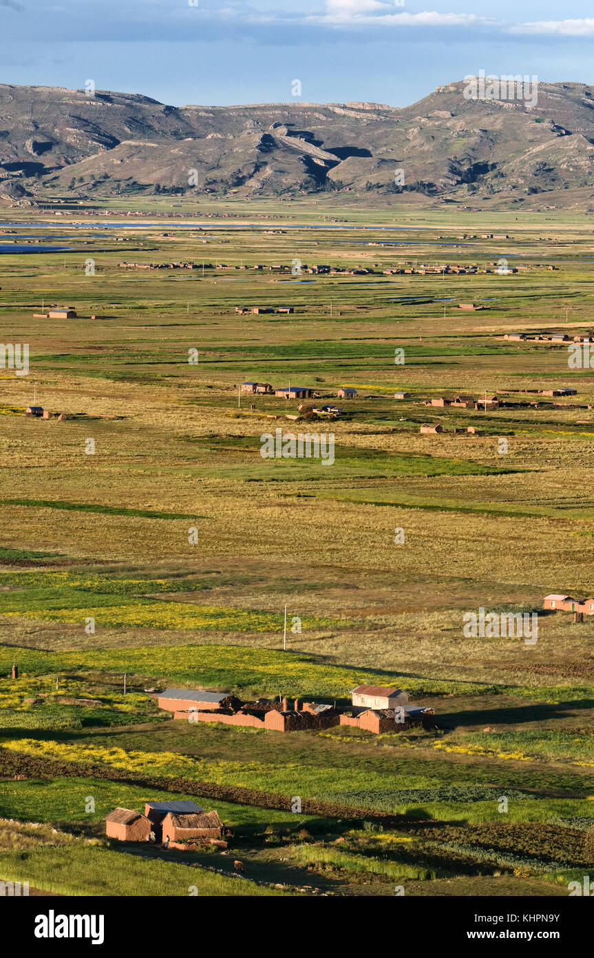 Vista de algunas casas aisladas en el altiplano peruano no lejos de Juliaca y el lago Titicaca, Puno, Perú. Foto de stock
