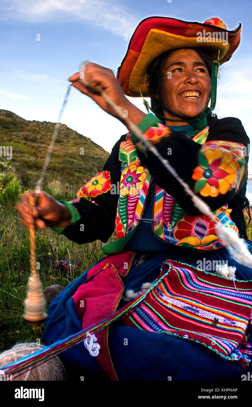Pueblo de llachón, la península de Capachica, cerca de Puno, Perú. Una mujer de la aldea de llachón vestida con un típico traje regional bordar gorras Foto de stock