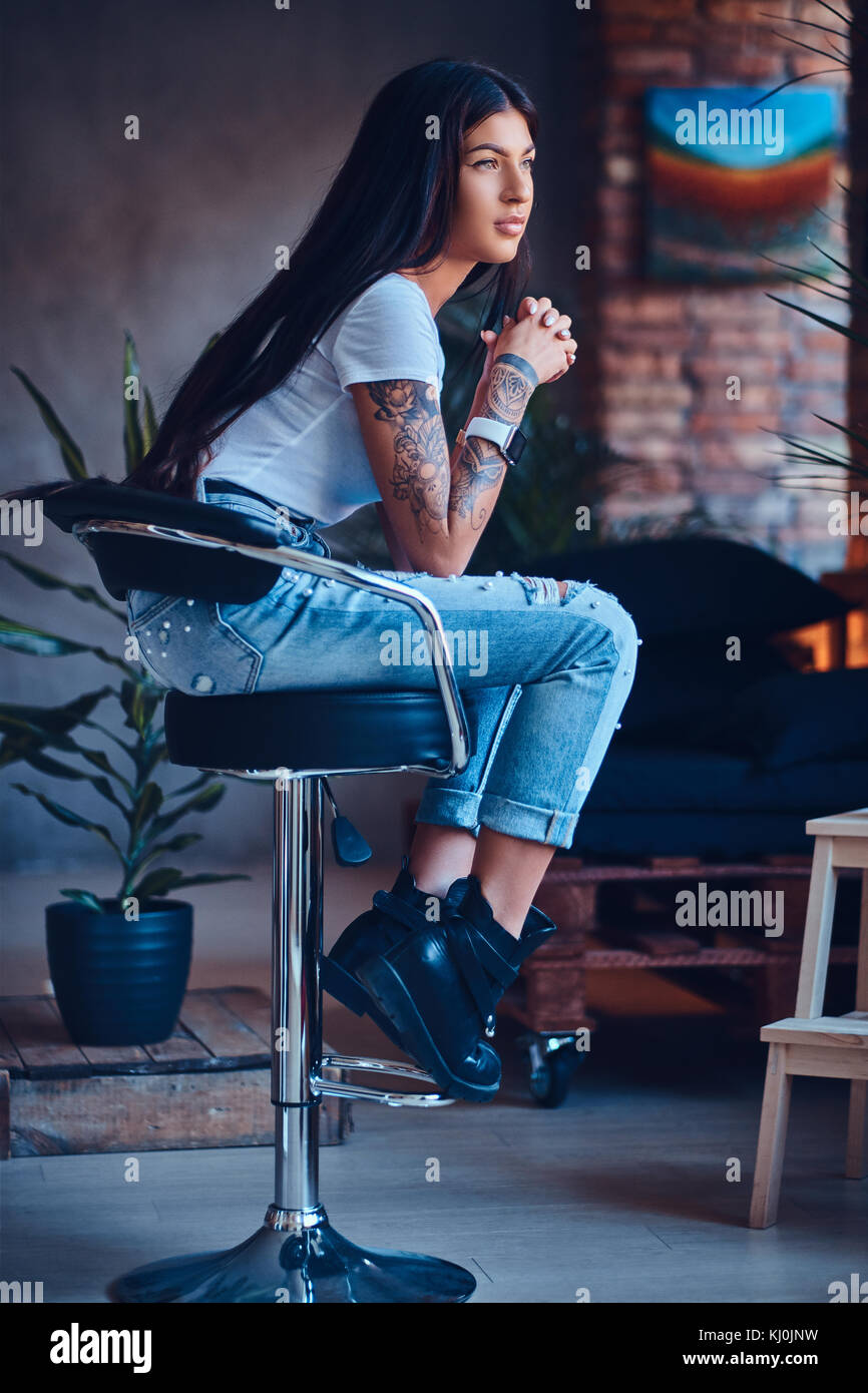 Una mujer vestida con jeans y botas negras Fotografía de stock - Alamy