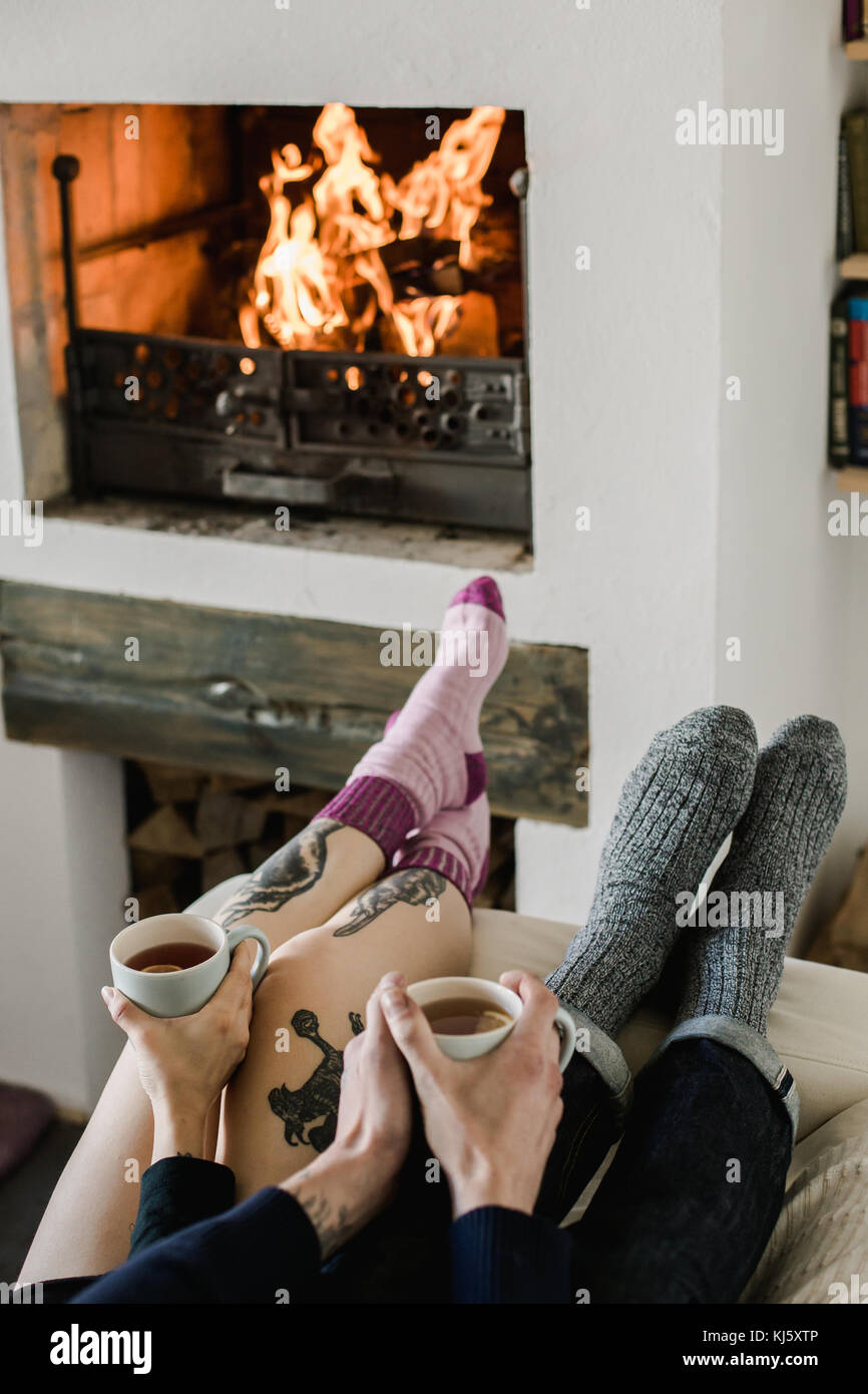 Pies de lana. par relajarse con una taza de bebida caliente y calentar sus  pies en calcetines de lana. Cierre en pies. de invierno y Navidad  vacaciones concepto Fotografía de stock -