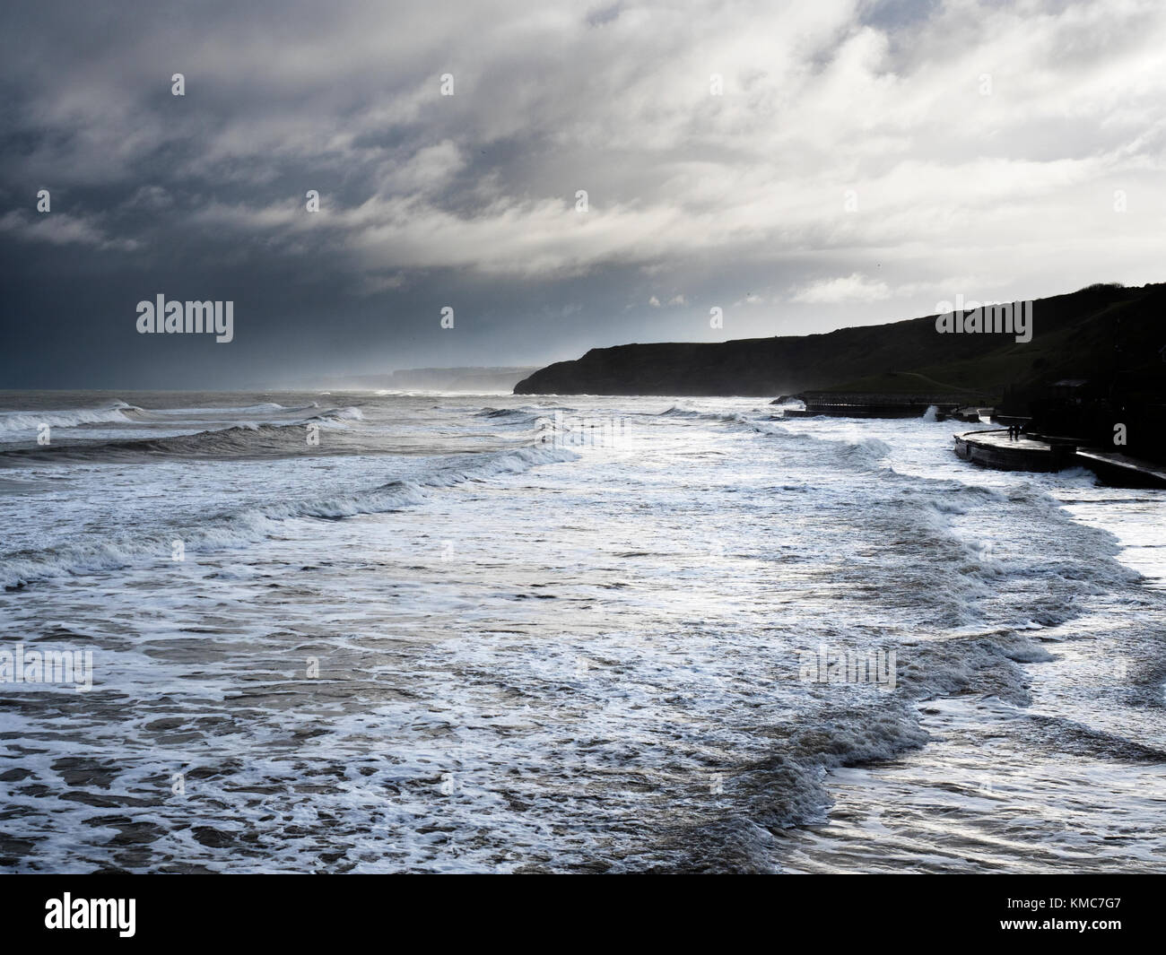 Las olas que rompen en la orilla con marea alta, en el sur de la bahía en invierno Scarborough North Yorkshire Inglaterra Foto de stock