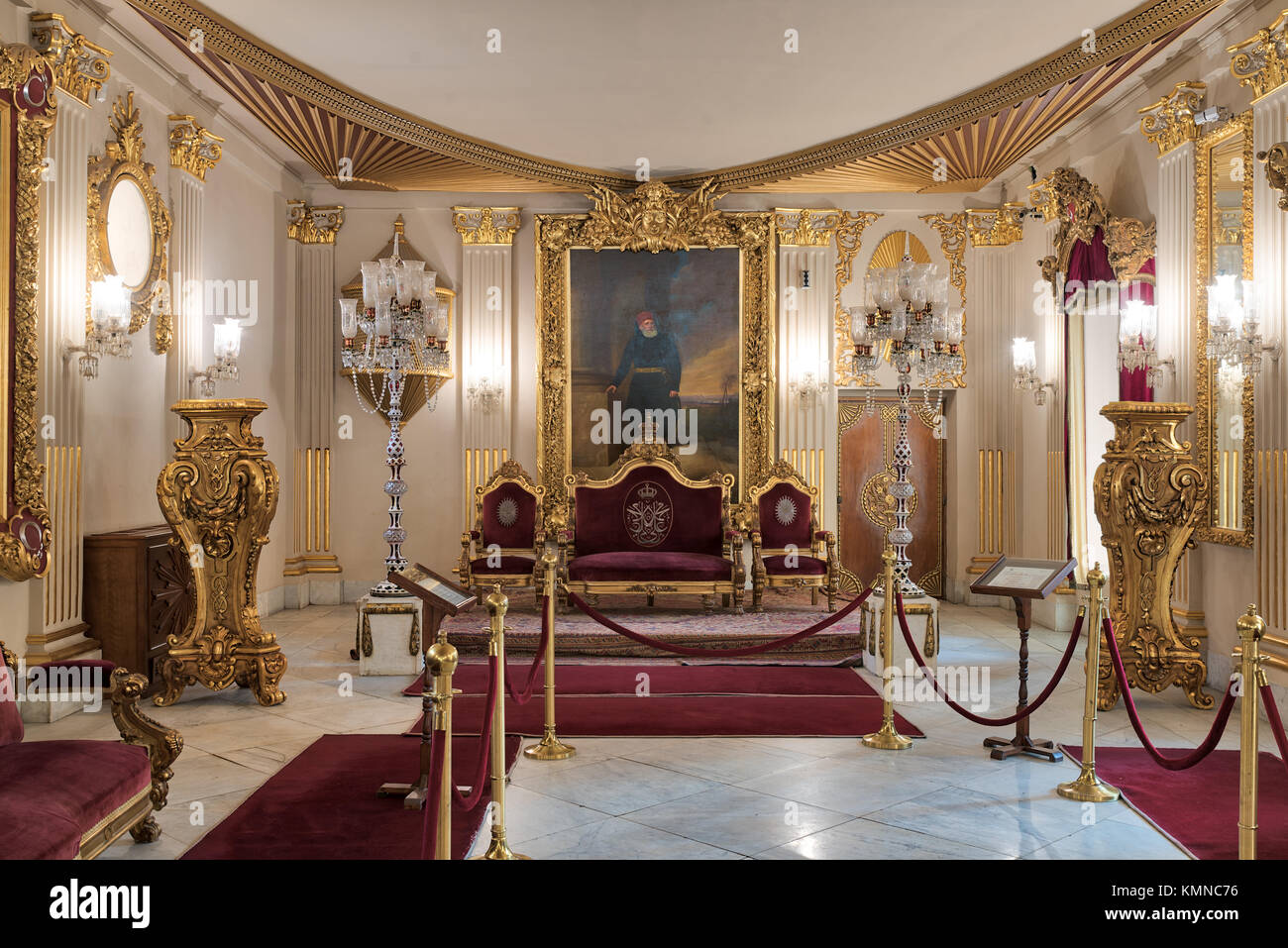 El Cairo, Egipto - Diciembre 2, 2017: en el Salón del Trono del Palacio Manial del Príncipe Mohammed Ali Tewfik rojo chapado en oro con sillones, lámparas de piso de antigüedades, ornat Foto de stock