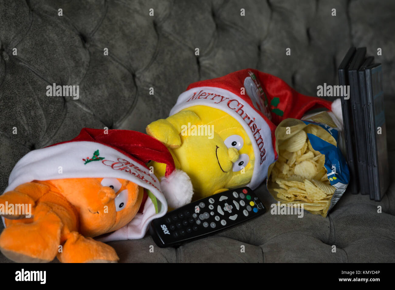 Concepto de imagen festiva, viendo la televisión de Navidad - Muñeco de  peluche con control remoto de la televisión y recipiente de patatas fritas  Fotografía de stock - Alamy