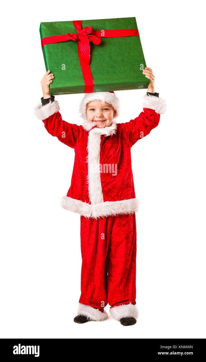 Adorable muchacho de 5 años vistiendo trajes de Santa Claus, un gran regalo de Navidad, fondo blanco. Foto de stock