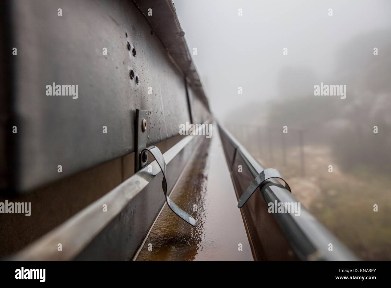 Canaleta de desagüe en el techo con sistema de goteo de niebla. Closeup. Foto de stock