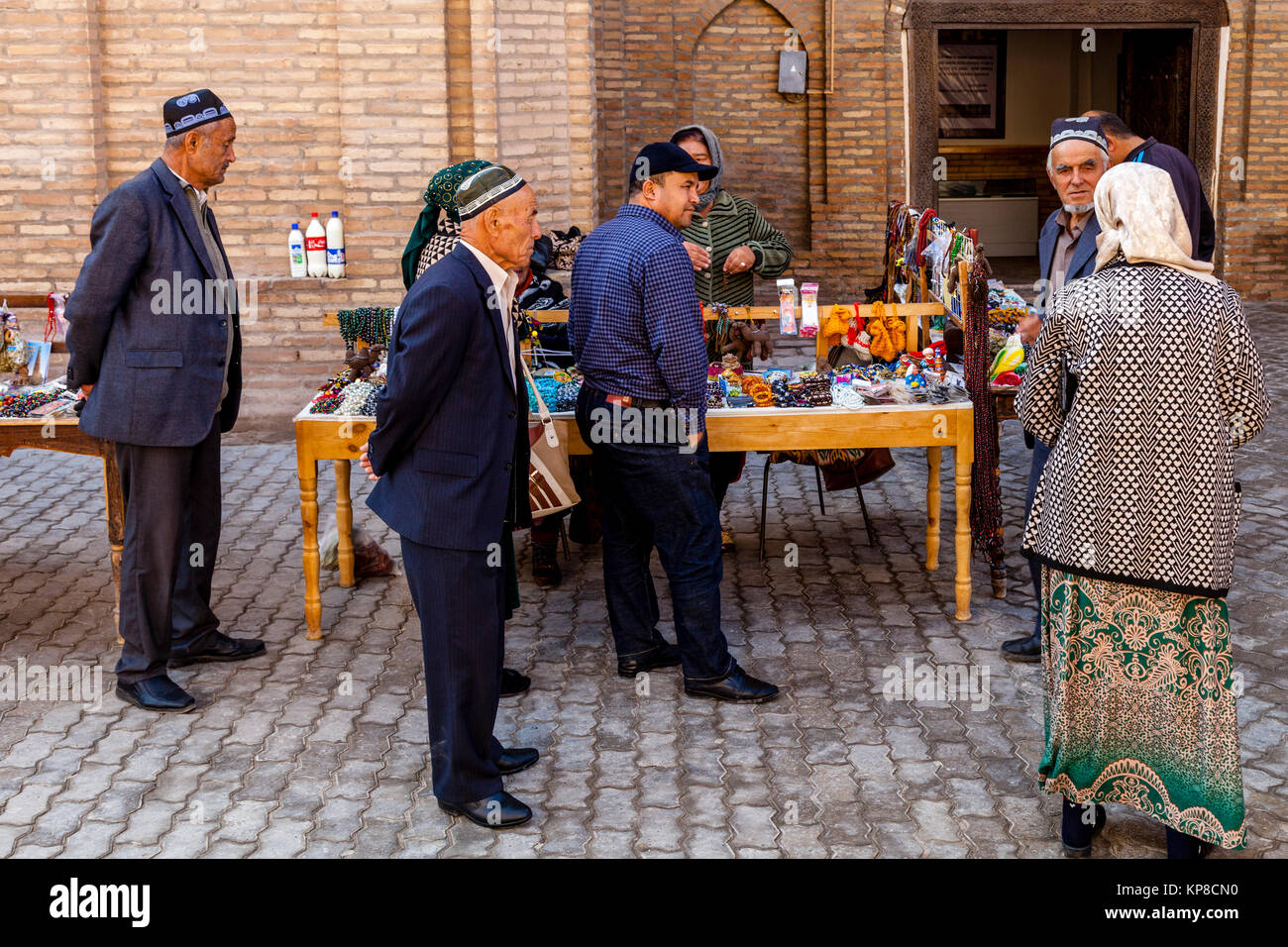 Los turistas uzbeko para compras de baratijas y souvenirs en un colorido recuerdo Cala, Khiva, Uzbekistán Foto de stock