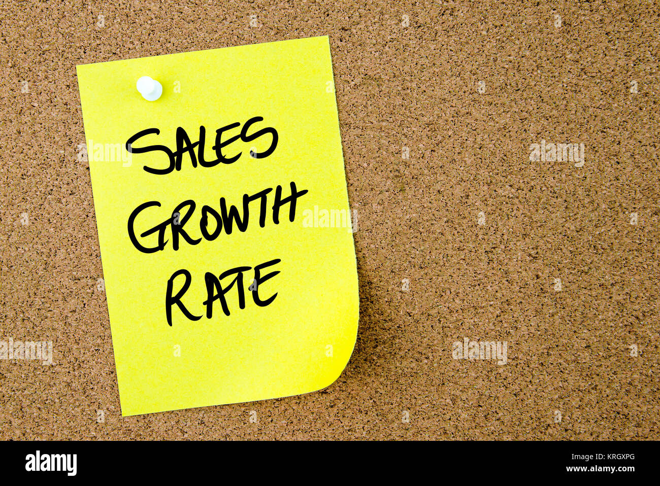 La tasa de crecimiento de ventas texto escrito en papel amarillo nota Foto de stock