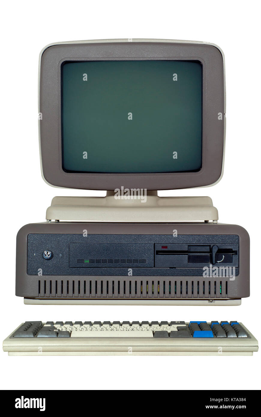 Equipo antiguo (finales de los 80's) con un sistema horizontal de unidad, una unidad para disquetes de 6 pulgadas y un monitor CRT y un teclado aislado Foto de stock