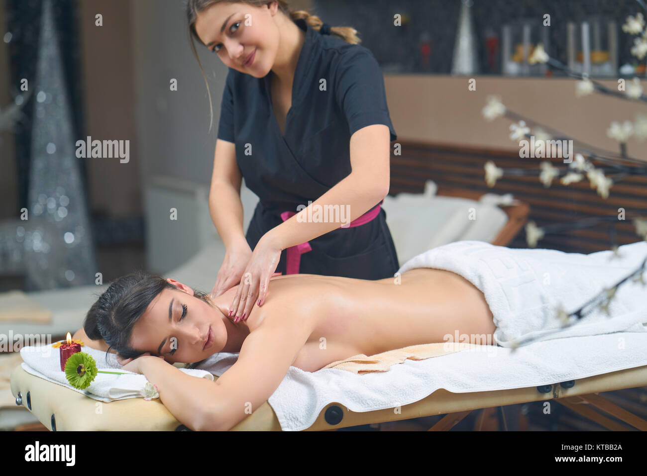 Spa mujer. Mujeres disfrutando relajante masaje de espalda en cosmetología Spa center. El cuidado del cuerpo, cuidado de la piel, el bienestar, la salud, el concepto de tratamiento de belleza. Foto de stock