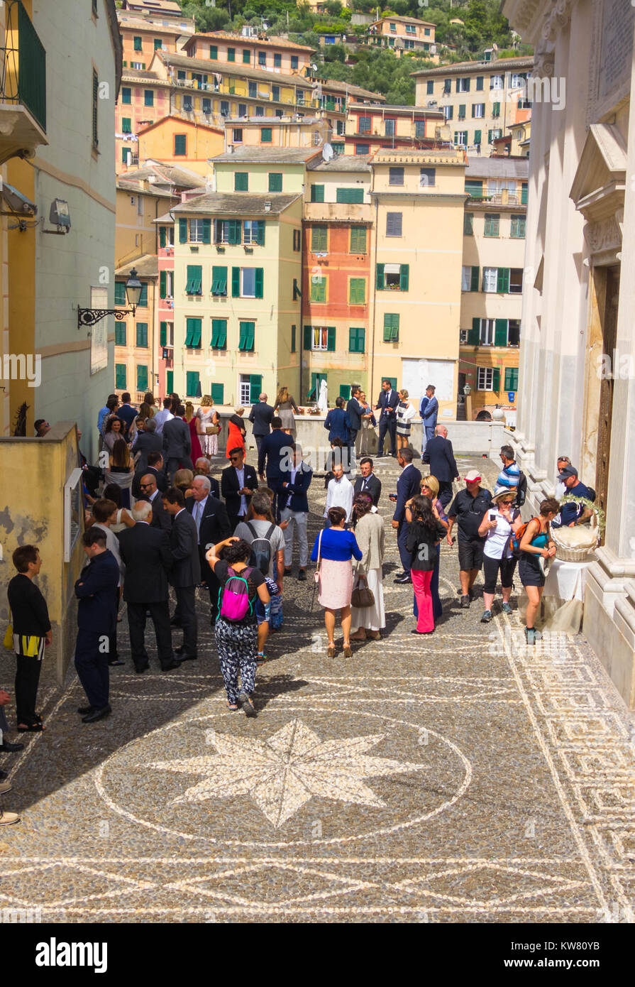 Los turistas se mezclan con los invitados a la boda fuera de la Basílica di Santa Maria Assunta Camogli Italia Foto de stock