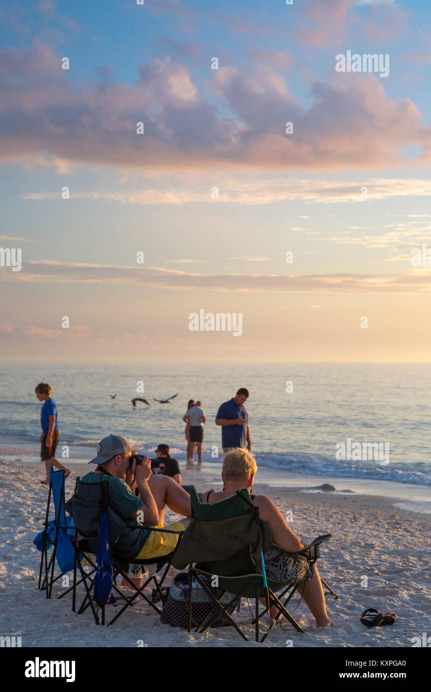 Observar y fotografiar atardecer en una tarde de invierno, Barefoot Beach, Naples, Florida, EE.UU. Foto de stock