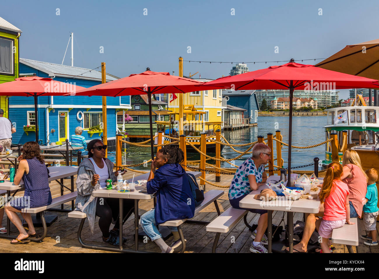 El comedor al aire libre en Fisherman's Wharf en Victoria, Canadá, una atracción turística con quioscos de comida, tiendas y hogares de flotación o houseboats Foto de stock