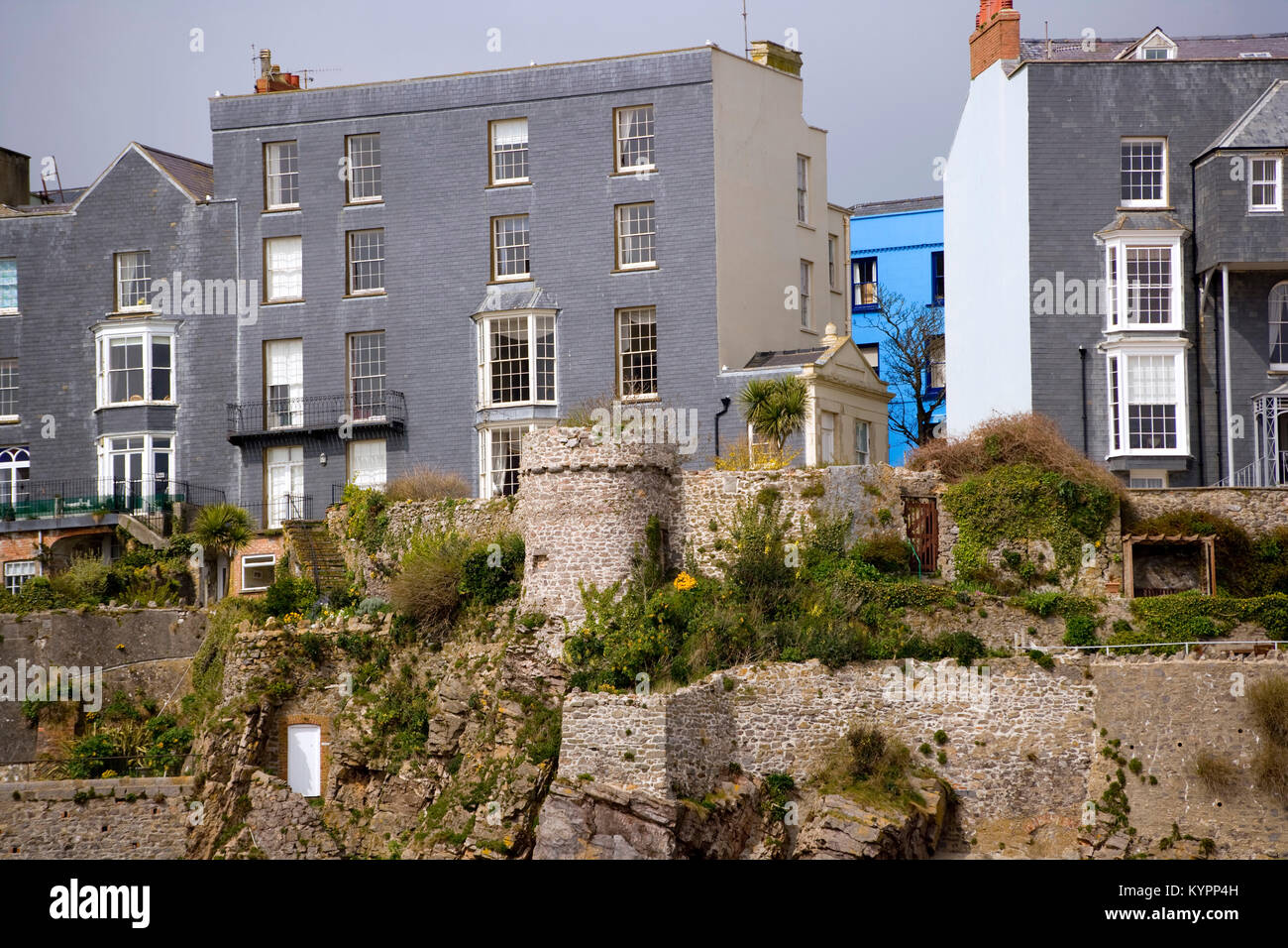 Una Casa Pintada De Azul Vibrante Destaca Entre Casas Grises En Los Acantilados Tenby Pembrokeshire Gales Reino Unido Fotografia De Stock Alamy