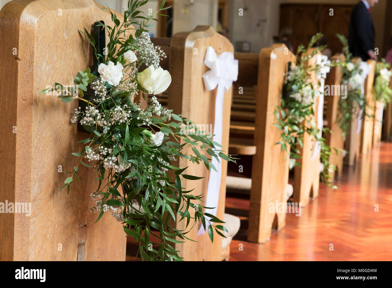 Los bancos de la Iglesia decorado con flores en una boda Fotografía de  stock - Alamy