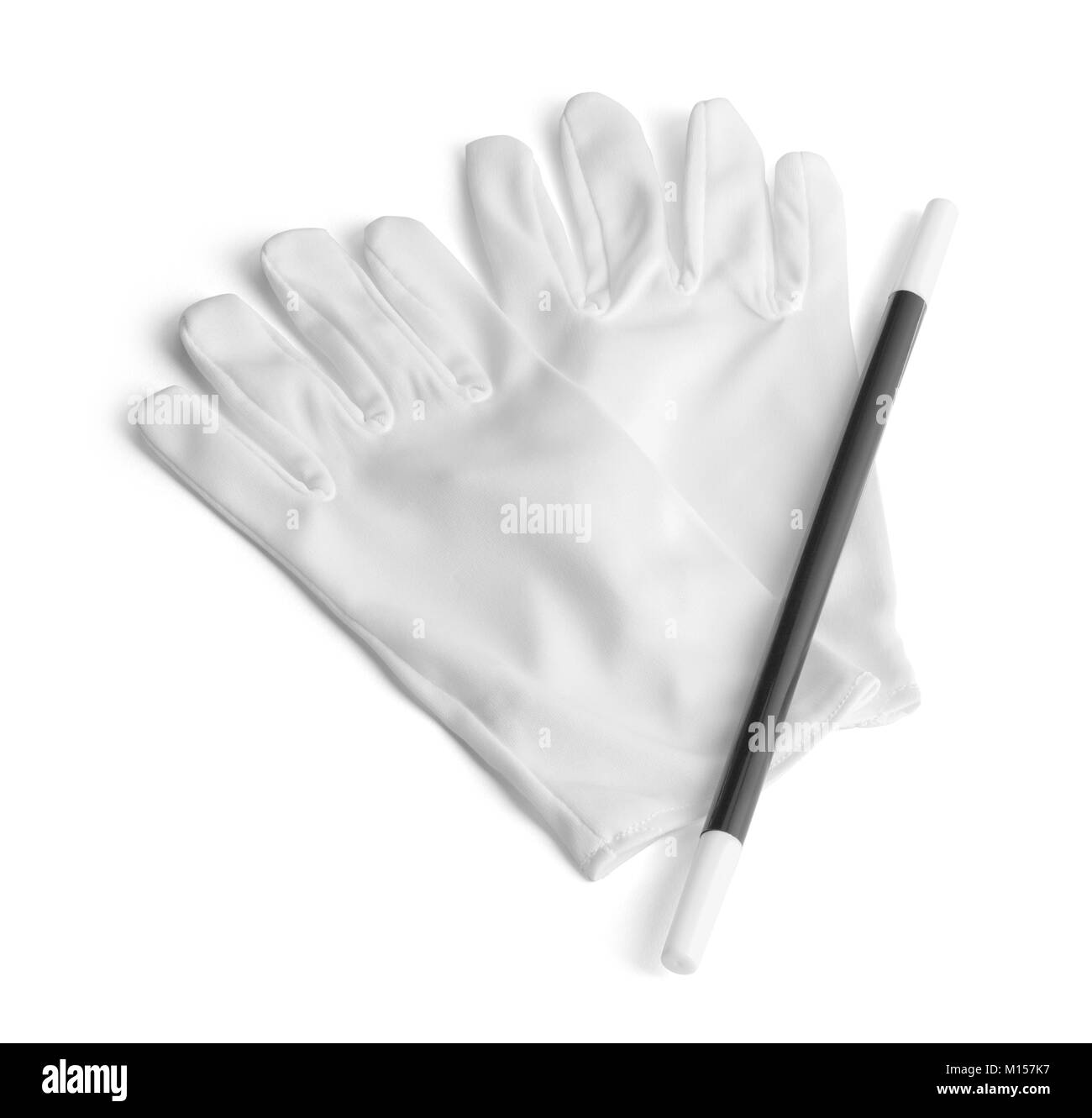 Dos guantes blancos y una varita mágica aislado en blanco. Foto de stock